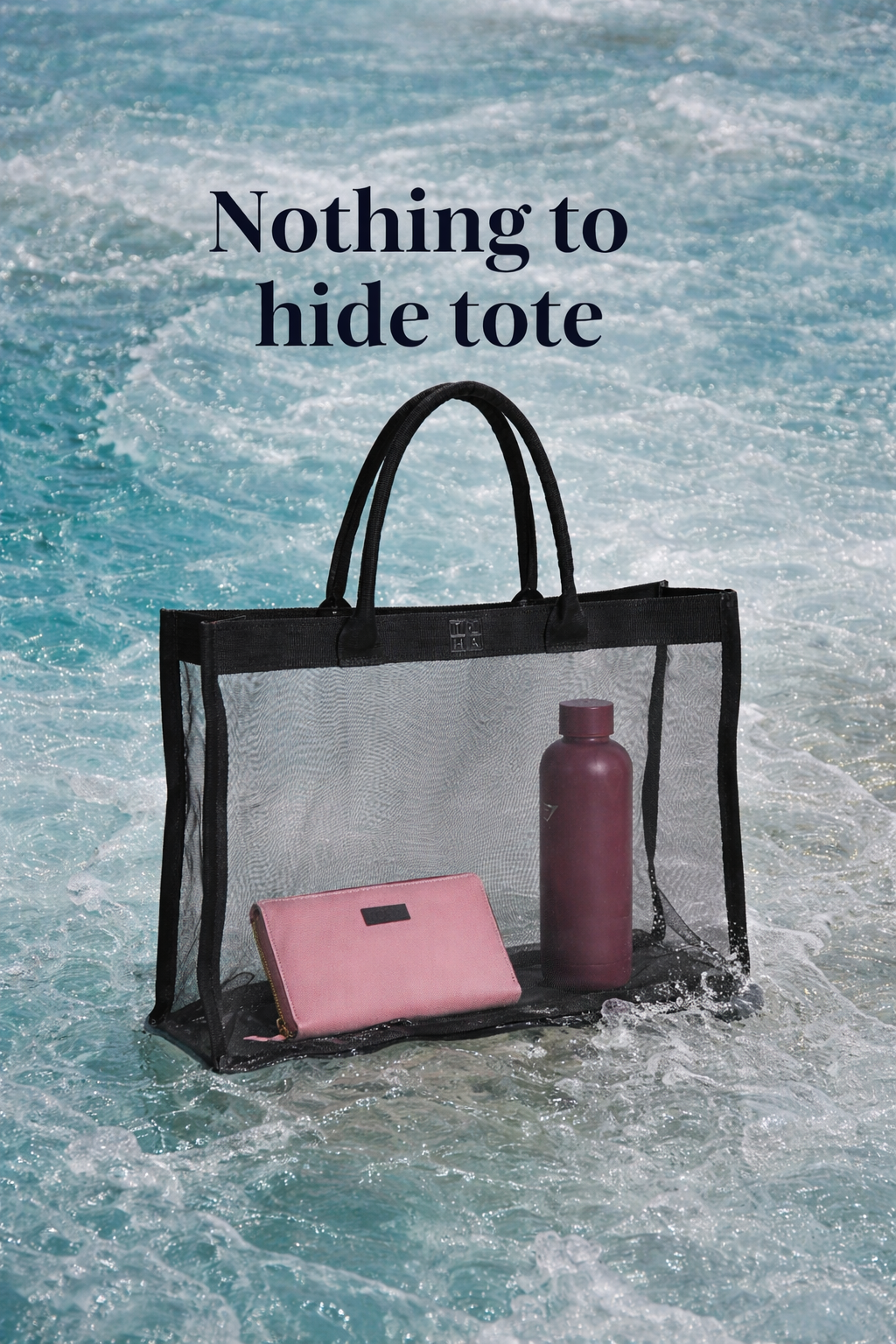 Transparent tote bag with pink item and purple bottle in water, text 'Nothing to hide tote' above.
