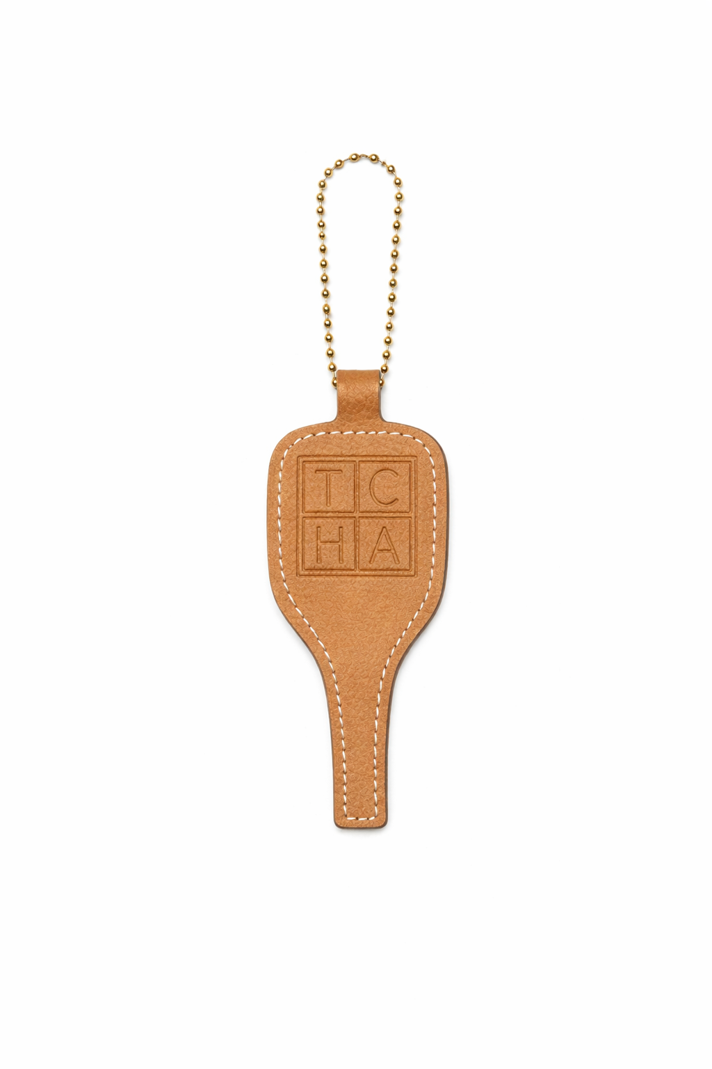 Brown pickleball leather keychain with 'TCHA' branding on a white background
