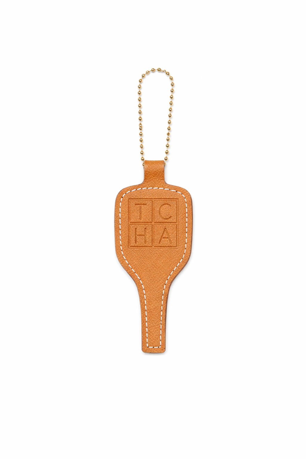 Brown leather pickleball keychain with 'TCHA' branding on a white background
