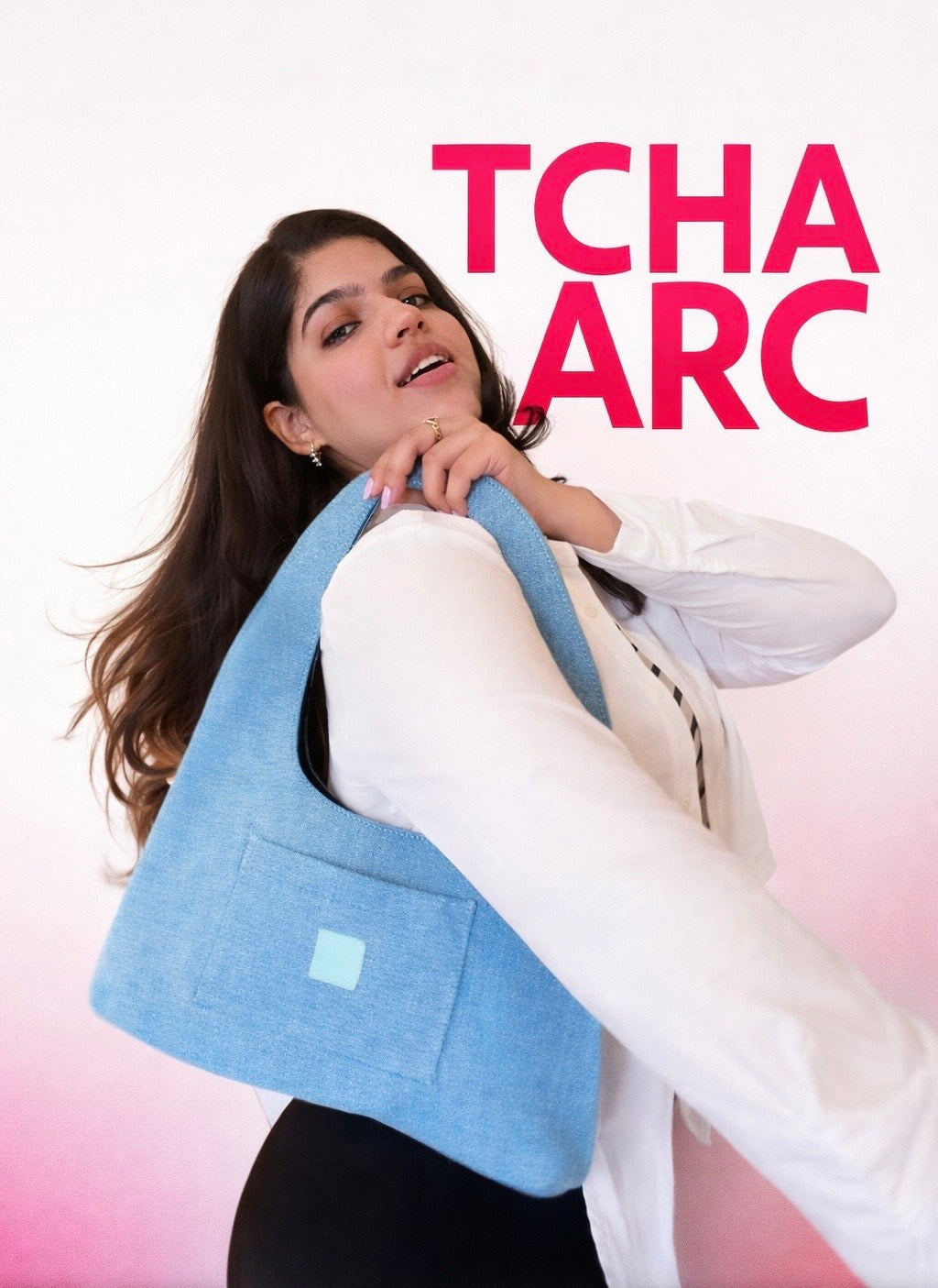 Woman holding a blue denim bag with 'TCHA ARC' branding on a gradient background