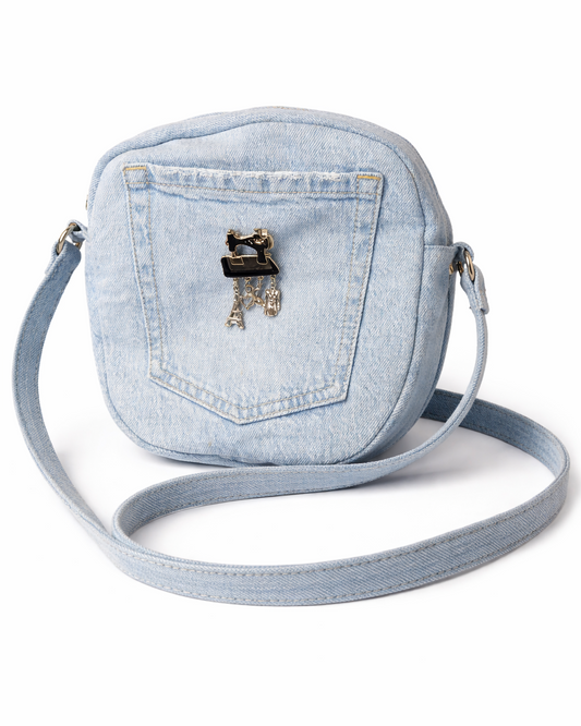 Light blue denim crossbody bag with a decorative clasp on a white background