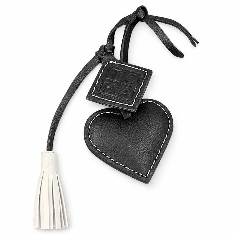 Black heart-shaped keychain with tassel on a white background