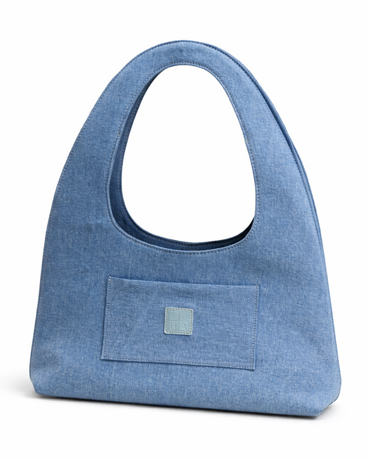 Blue handbag with a visible brand label on a white background