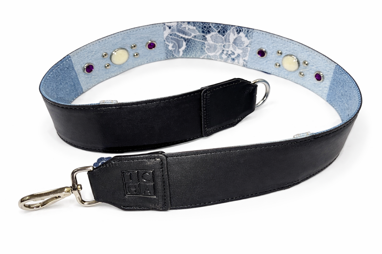 Black leather strap with floral patterned interior on a white background